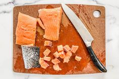 the fish is cut up and ready to be served on the cutting board with a knife