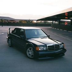 a black mercedes benz parked in a parking lot