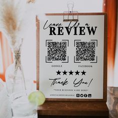 a sign that says you're a review on it next to a vase with flowers