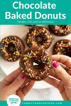 chocolate baked doughnuts with sprinkles on top in front of a white plate