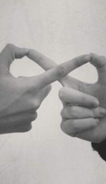 two hands making a heart shape with their fingers