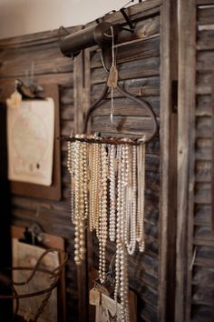 a wooden wall with beads hanging from it