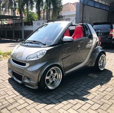 a smart car parked in front of a building