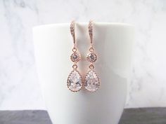 Rose gold crystal earrings. The rose gold earrings are perfect for the bridal earrings for the bride who loves something simple but with a cubic zircon sparkle that make them really standout. They design is perfect for weddings, proms and special occasions. They made a lovely gift for wives, mother of the bride and bridesmaids. The earrings made with rose gold plated teardrop pendant attached to a zircon connector and zircon encrusted ear hook. Rose Gold-plated Bridal Earrings For Wedding, Sparkling Rose Gold Bridal Earrings Gift, Rose Gold Teardrop Earrings For Bridesmaids, Elegant Rose Gold Bridesmaid Earrings, Rose Gold Cubic Zirconia Earrings For Bridesmaids, Elegant Rose Gold Bridal Earrings With Sparkling Stones, Rose Gold Wedding Earrings, Gold Bridesmaid Earrings, Gold Earrings Bridal