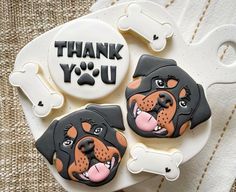 two decorated cookies with dogs on them and the words thank you