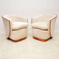 a pair of chairs sitting next to each other on top of a white carpeted floor