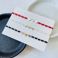 Customizable Matching Bracelet set for 3 with heart charms in 3 different colors 𝔸𝕓𝕠𝕦𝕥 𝕥𝕙𝕖 𝕓𝕣𝕒𝕔𝕖𝕝𝕖𝕥𝕤 - 2mm elastic transparent beading string - 3mm seed beads colors black, white, red - 2mm spacer beads color: silver - 5mm silver plated heart charms - silver plated lobster clasp and 4cm extender chain 𝕊𝕚𝕫𝕖𝕤  The basic size is 15cm + 4cm extender chain so the bracelets can be adjusted up to 19cm  - If you have your personal size please mention that in Personalization box ℙ𝕖 Best Friend Matching Bracelets, Best Friend Matching, Friends Birthday Gift, Best Friends Birthday, Beads Colors, Birthday Gifts For Best Friend, Friends Birthday, White Bracelets, Red Bracelets