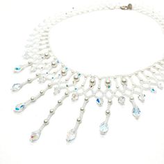 This Beaded Swarovski Crystal and Pearl Bridal Statement Necklace is a collar style with gorgeous teardrop pendants. It is and one of a kind.  All My pieces are made with the finest materials available. I only use genuine Swarovski Crystals and Pearls. They are strung on Fireline which is knotted throughout the piece. Sterling silver or gold filled clasps are standard making my pieces heirloom quality to be handed down to future brides. I used 6 and 4 mm white Swarovski Pearls, 6 and 4 mm Clear AB Swarovski bicones, 9 mm teardrop crystals, white pearl finish seed beads and a sterling clasp. This took 10 hours to make but the finished product is sooo worth it! If you want to make a statement, this is your piece. This is the one and only piece exactly like this and is ready to ship now. I wi Beaded Drop Jewelry For Wedding, Elegant Beaded Teardrop Pendant Crystal Necklace, Handmade Drop Necklaces For Wedding, Elegant Beaded Drop Necklace, Handmade Elegant Drop Beaded Necklaces, Beaded Teardrop Wedding Jewelry, Elegant Drop Beaded Necklaces, White Crystal Dangle Necklaces, White Crystal Teardrop Pendant Necklace