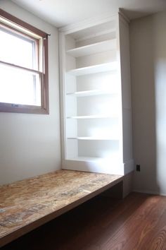 the empty room is clean and ready to be used as a bookcase or office