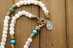 This rosary combines durability with elegance and features brown paracord rope, teal Our Father beads, and semi-transparent cream-colored Hail Mary beads to create a stunning design that will inspire your faith.Designed specifically for those who believe in the power of prayer and seek to save the world one Hail Mary at a time, our Divine Hope rosary is handmade with love by our small Catholic family. Each element has been meticulously selected and tested to ensure its ability to withstand life' Handmade Adjustable Spiritual Rosary, Handmade Adjustable Rosary For Meditation, Adjustable Handmade Rosary For Meditation, Paracord Rope, Paracord Rosary, The Power Of Prayer, Hope Design, Catholic Family, Our Father