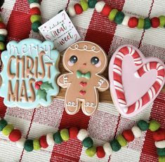 three decorated cookies sitting on top of a table