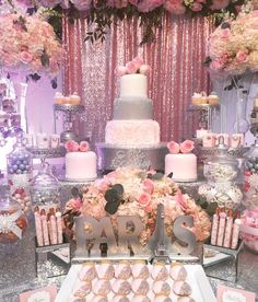 a table topped with lots of cakes and desserts