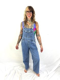 Nice overalls Size medium. Great vintage shape 100% cotton Made in Bangladesh Lying flat: 18" across waist 21" across hips 50" top to bottom front center 28" inseam High Rise Medium Wash Cotton Overalls, High Rise Cotton Overalls In Medium Wash, Vintage Light Wash Overalls With Pockets, Vintage Cotton Denim Jumpsuit In Medium Wash, Vintage Light Wash Denim Overalls, 90s Inspired Light Wash Cotton Jeans, Medium Wash Cotton Straight Leg Overalls, Vintage Blue Cotton Overalls, 90s Style Blue Cotton Jeans