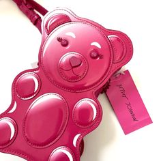 Cute Betsey Johnson Teddy / Gummy Bear Novelty Crossbody Bag (Azalea Rosebud) Material - Patent Leather Size - 5" W X 8" H X 3" D Chain / Patent Leather Strap Patch Applique With Studded Details. Zip Closure Logo Plaque New And Original Item Comes From A Smoke Free Home. Playful Pink Party Bag, Playful Pink Crossbody Bag, Pink Playful Shoulder Bag, Fun Pink Party Bags, Novelty Purses, White Wallet, Betsey Johnson Purses, Unique Backpacks, Unique Handbag