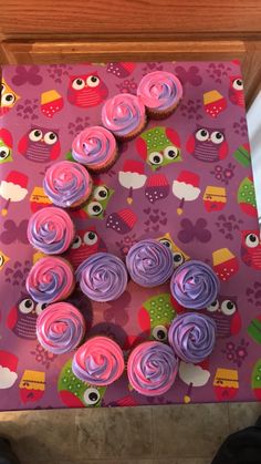 the cupcakes are decorated with pink and purple icing