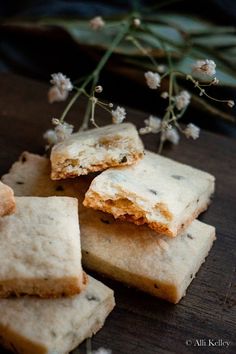 small crackers are stacked on top of each other with flowers in the back ground