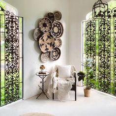 a living room filled with lots of furniture and decor on top of a white floor