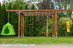 an outdoor play area with swings, basketball hoop and climbing frame for children to play in