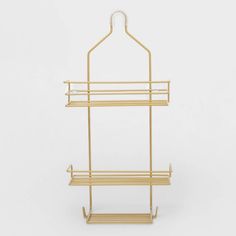 a gold metal and wood shelf with two shelves on each side, one holding a coat rack