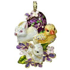 an ornament with some animals and flowers on the bottom one has a duck, rabbit, and bird in it