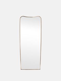 a large rectangular mirror on a white wall