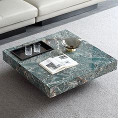 a marble coffee table sitting on top of a carpeted floor