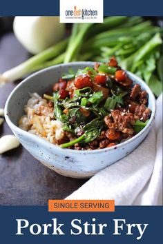 a bowl filled with meat and vegetables on top of a table