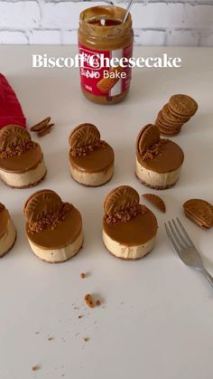 small heart shaped cookies with chocolate frosting in the middle on a white surface next to a jar of peanut butter