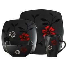 a black and red dinnerware set with flowers on it