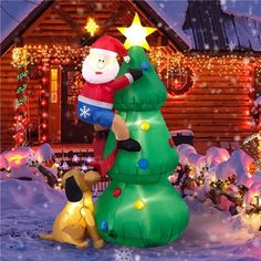 a large inflatable christmas tree with a man and dog