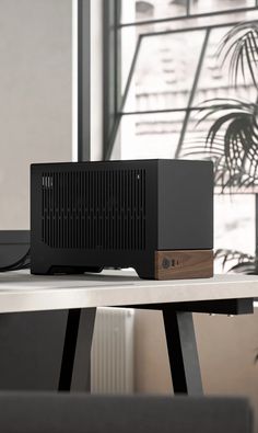 a black and wooden device sitting on top of a table