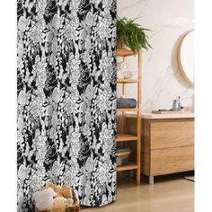 a black and white shower curtain with flowers on it