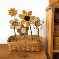 a basket filled with flowers sitting on top of a wooden table