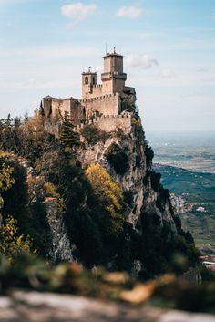 an old castle perched on top of a mountain