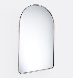 a mirror that is on the wall in front of a white background with no people around it