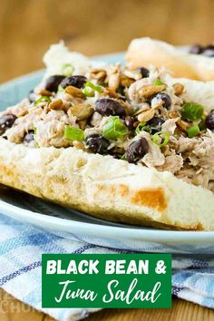 black bean and tuna salad on a white plate with a blue checkered napkin next to it