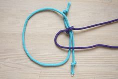 a blue and purple rope is on top of a wooden table