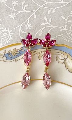 LONG earrings featuring 15x7mm and 10x5mm Swarovski crystals in an ombré of pinks.  Total earring length is 1 3/4 inch long. Post backs for pierced ears. Thanks for stopping by! Pink Dangling Earrings, Palette Rosa, Earrings Wedding Guest, Pink Crystal Earrings, Prom Earrings, Prom Jewelry, Etsy Bridesmaid Gifts, Pink Vibes, Fancy Jewellery