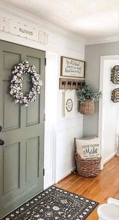 the entryway is decorated with wreaths, baskets and other items for decorating