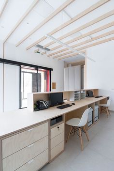 an empty office with two desks and chairs