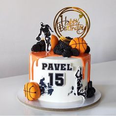 a birthday cake decorated with basketballs and blackberries