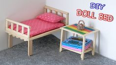 a doll bed and table in a room with the words diy doll bed on it