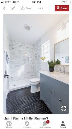 a white toilet sitting next to a bath tub under a window in a bathroom with black and white floor tiles