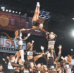 a group of cheerleaders are doing tricks in the air