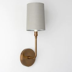 a wall light with a white shade on it