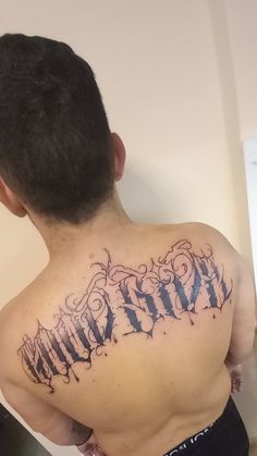 a man with a tattoo on his back