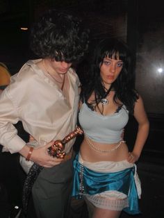 two people dressed in costumes standing next to each other