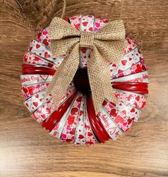 a red and white wreath with hearts on it