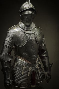 a knight in full armor standing with his hands on his hips