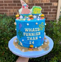 a blue cake with an image of spongebob on it that says what's funnier than 24